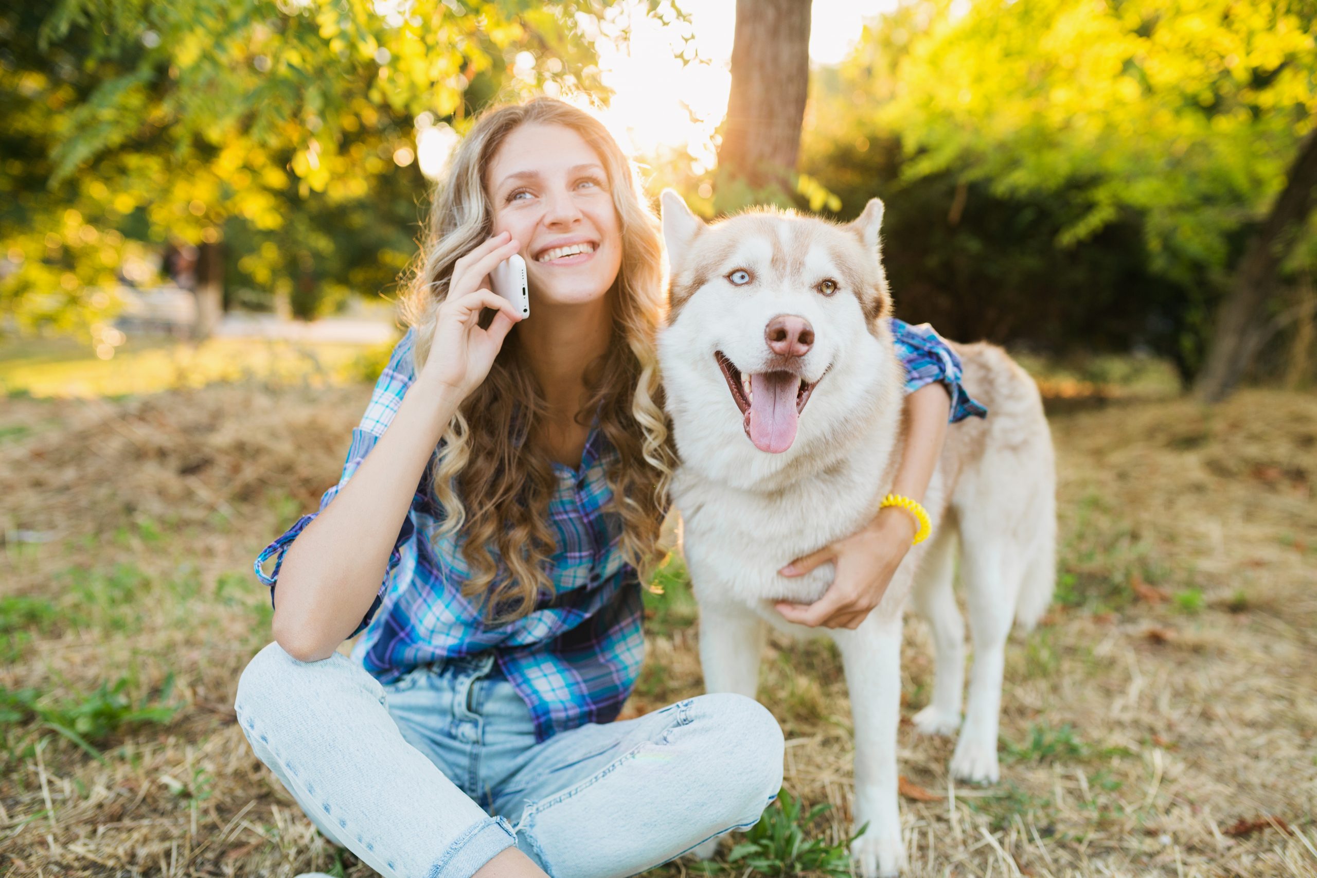 woman with dog talking on phone